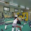 Persona in palestra su una macchina per allenamento.
