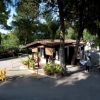 Edificio tra alberi con un cart da golf e persone.